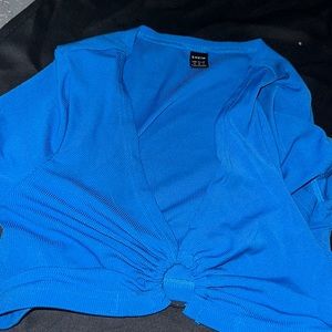 This is a royal blue crop top short sleeved shirt .